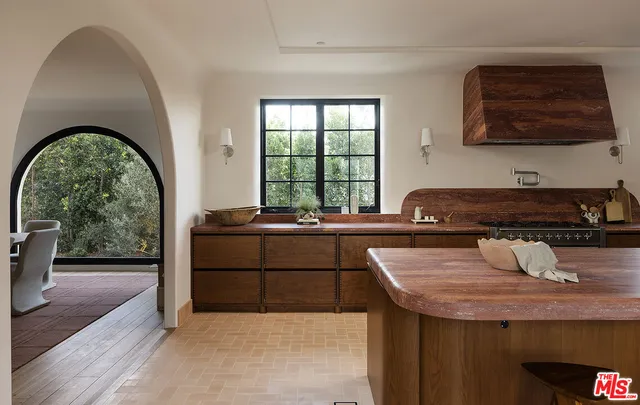 a kitchen with a sink a counter top space and cabinets
