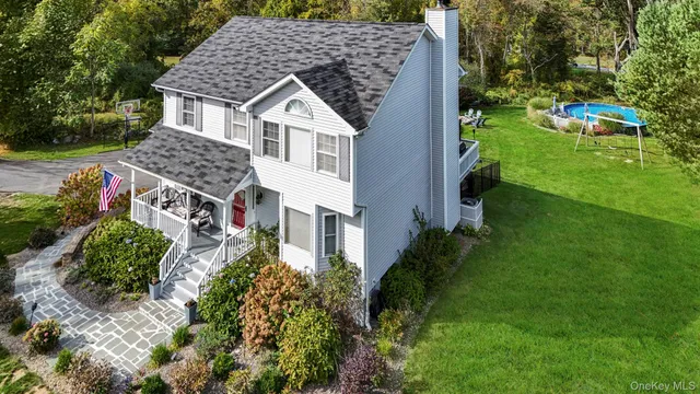 an aerial view of a house with a yard