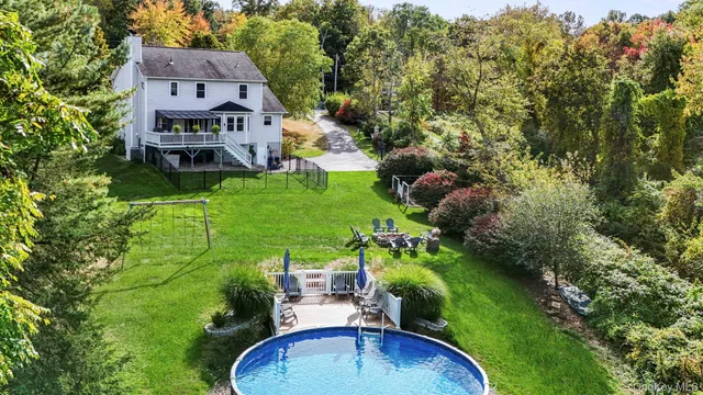an aerial view of a house with a yard and lake view