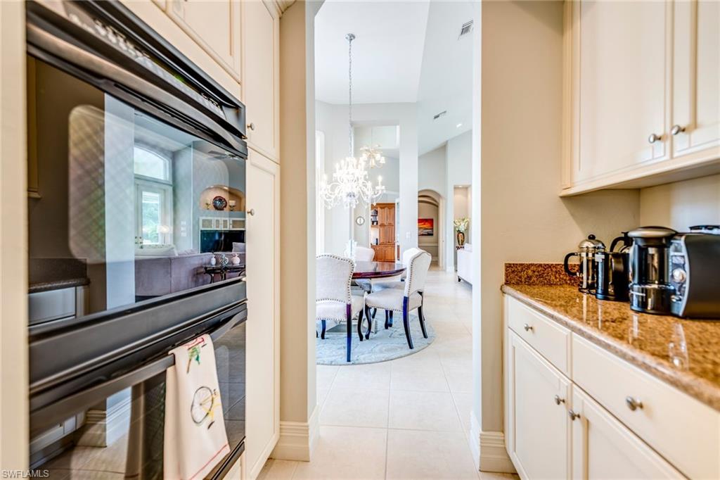 1160 Oleander Drive Naples, FL 34102 - Photo 15 of 31 a view of a kitchen with dining table and chairs