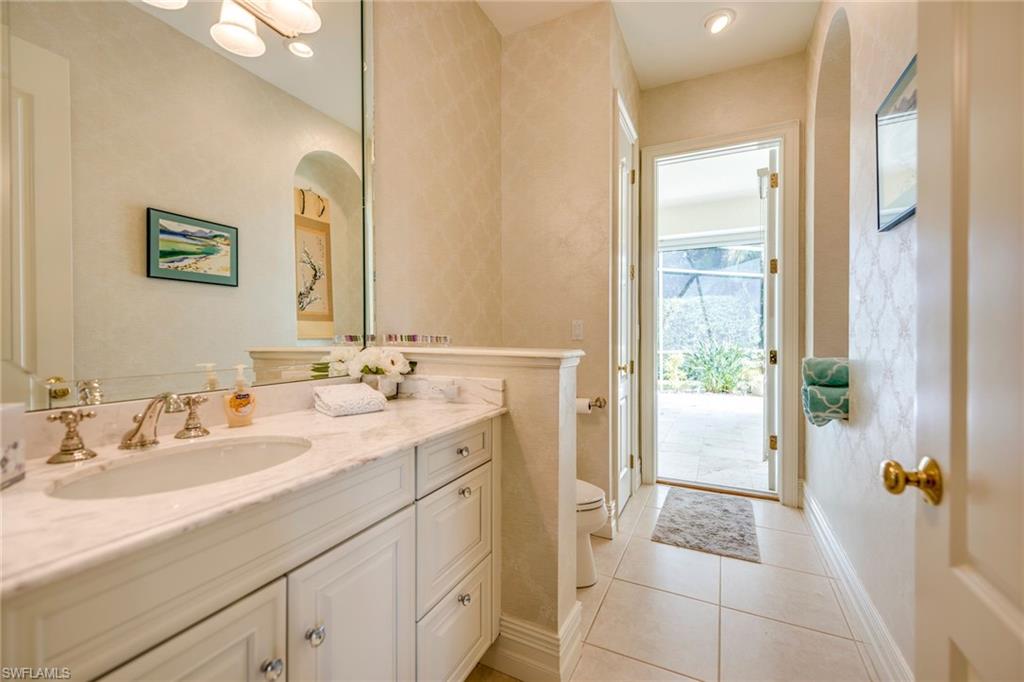 1160 Oleander Drive Naples, FL 34102 - Photo 18 of 31 a spacious bathroom with a shower sink and mirror