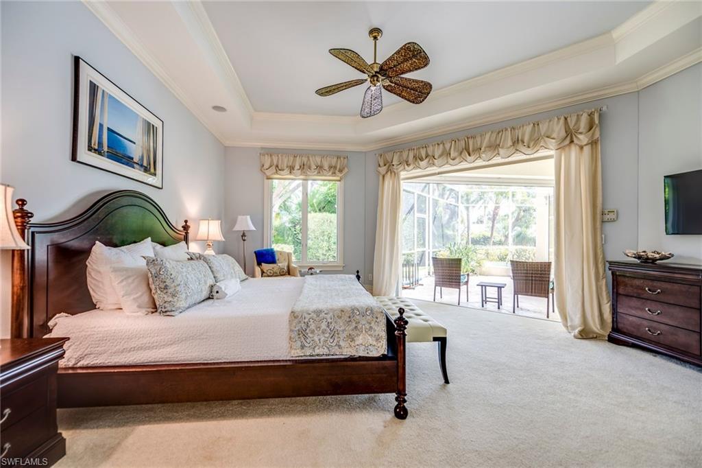1160 Oleander Drive Naples, FL 34102 - Photo 20 of 31 a bedroom with a large bed and a flat screen tv