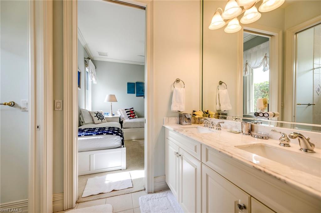 1160 Oleander Drive Naples, FL 34102 - Photo 25 of 31 a bathroom with a sink vanity granite tub and shower