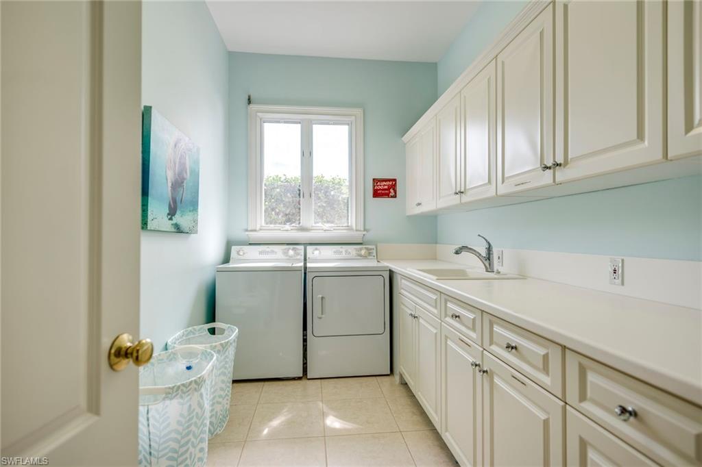1160 Oleander Drive Naples, FL 34102 - Photo 26 of 31 a utility room with cabinets washer and dryer