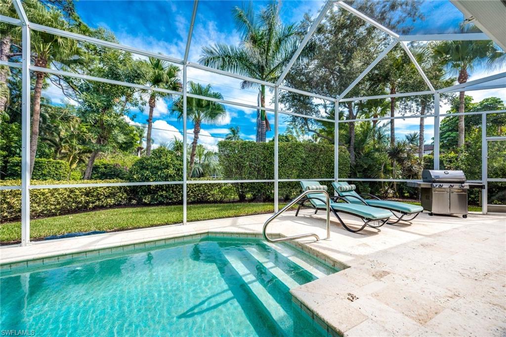1160 Oleander Drive Naples, FL 34102 - Photo 29 of 31 a view of a swimming pool with a bench and wooden fence