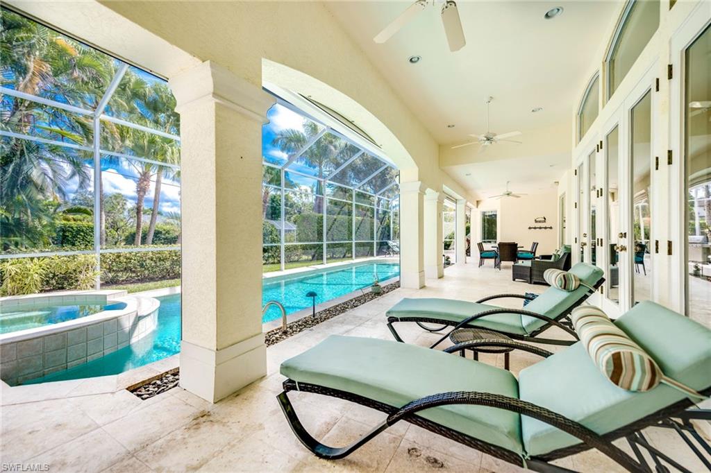 1160 Oleander Drive Naples, FL 34102 - Photo 30 of 31 a living room with furniture and a floor to ceiling window