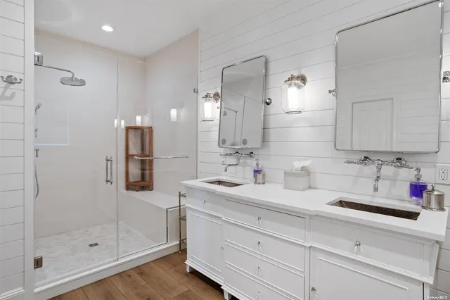 a bathroom with a shower sink and mirror