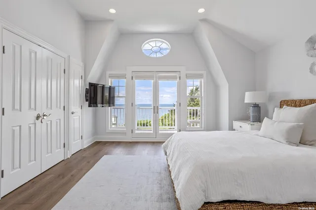a spacious bedroom with a bed and a large window