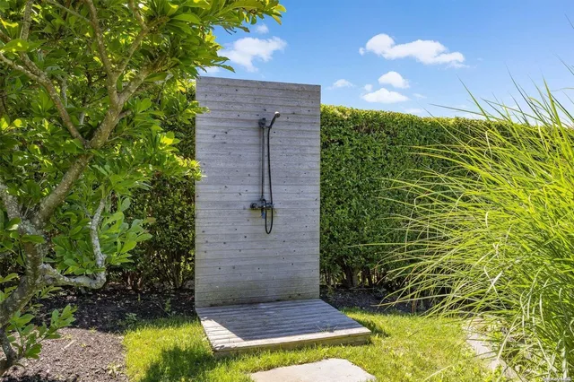 a view of brick house with a yard