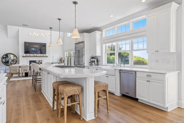 a kitchen with kitchen island granite countertop a sink dining table and chairs