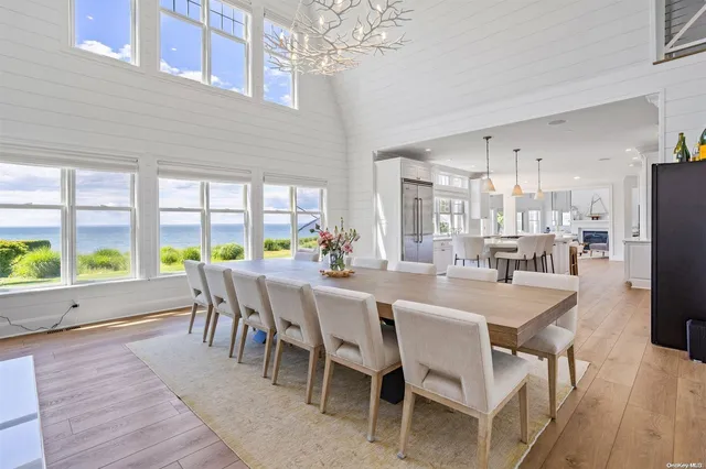 a dining room with furniture a chandelier and wooden floor