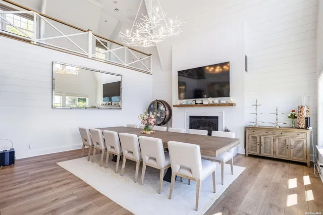 a view of a dining room with furniture wooden floor and a fireplace