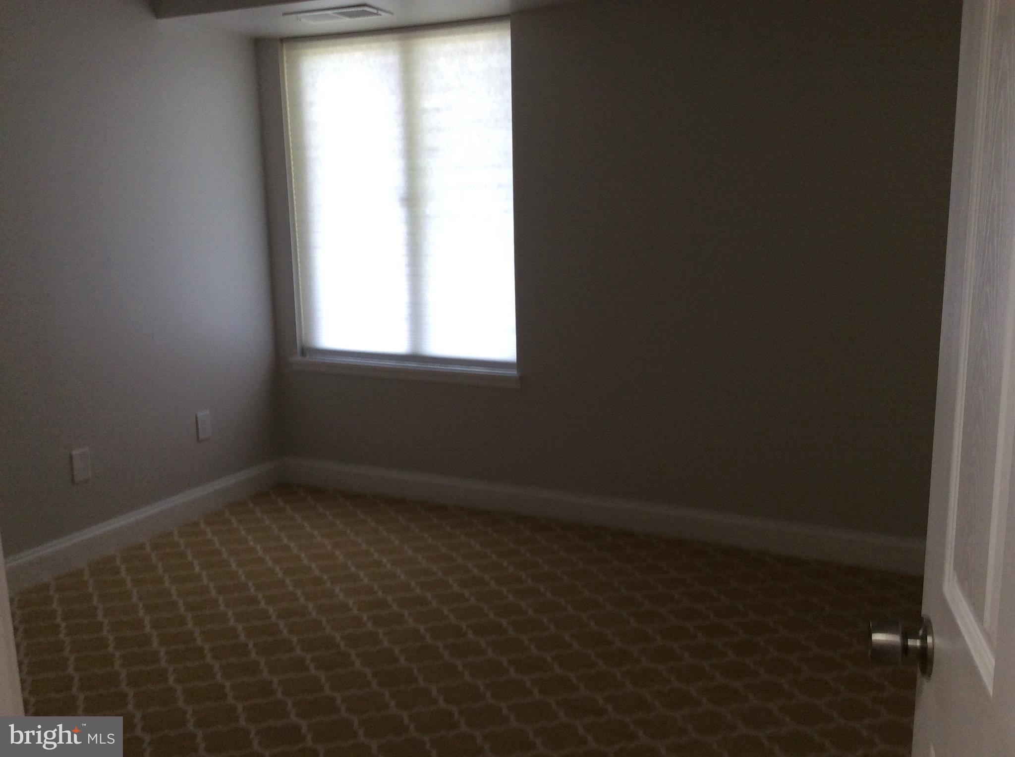 9633 White Acre Road, Unit A2 Columbia, MD 21045 - Photo 17 of 27 an empty room with a window