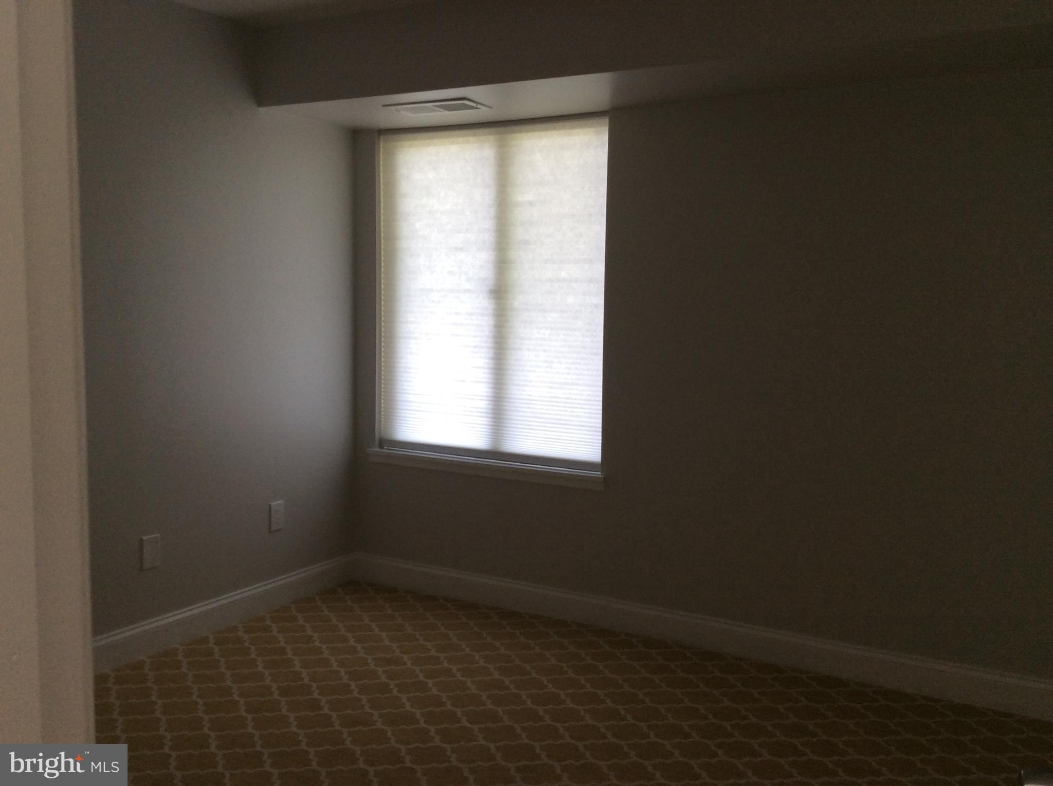 9633 White Acre Road, Unit A2 Columbia, MD 21045 - Photo 18 of 27 a view of an empty room with a window