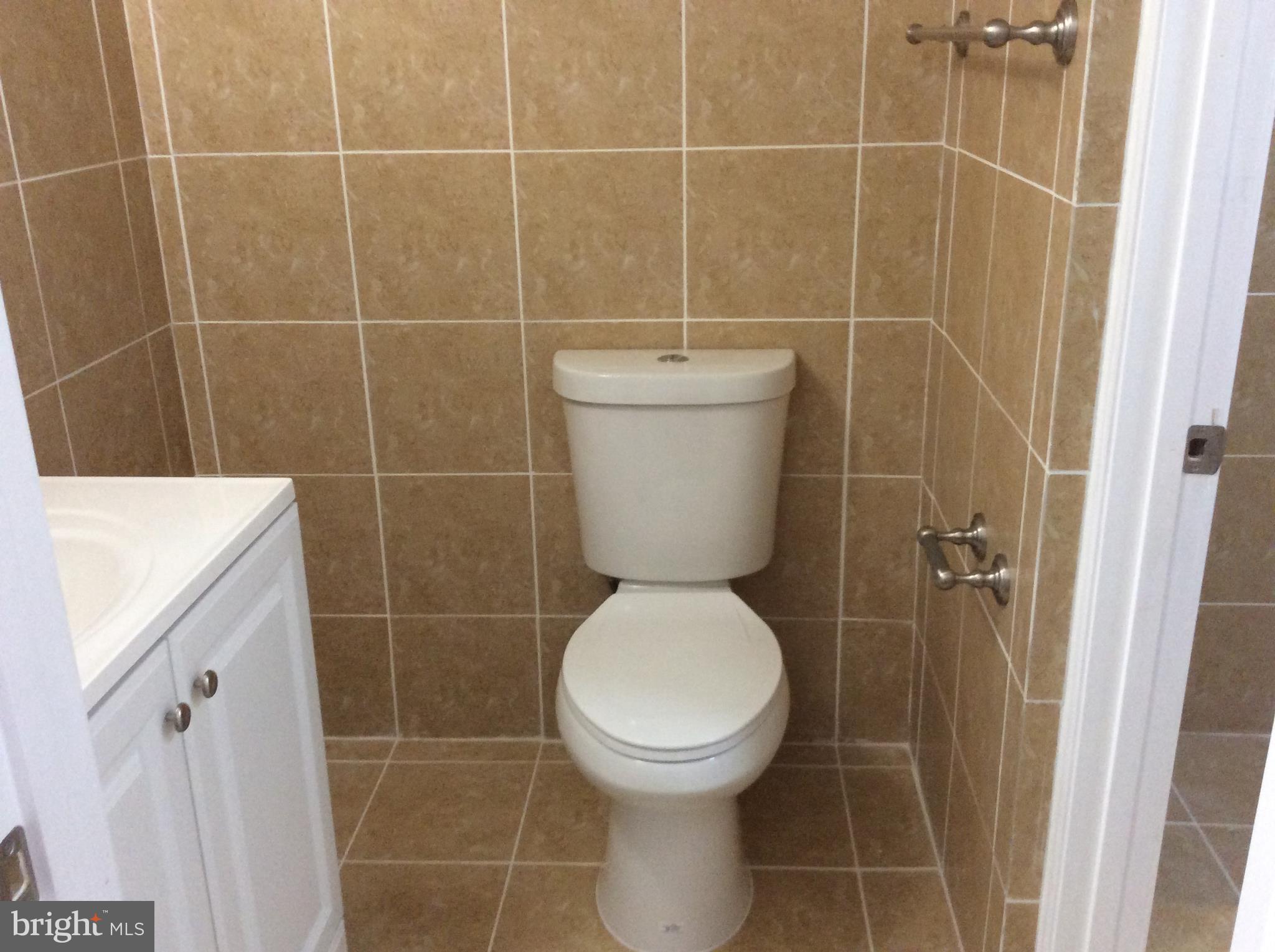 9633 White Acre Road, Unit A2 Columbia, MD 21045 - Photo 24 of 27 a bathroom with a toilet and a shower
