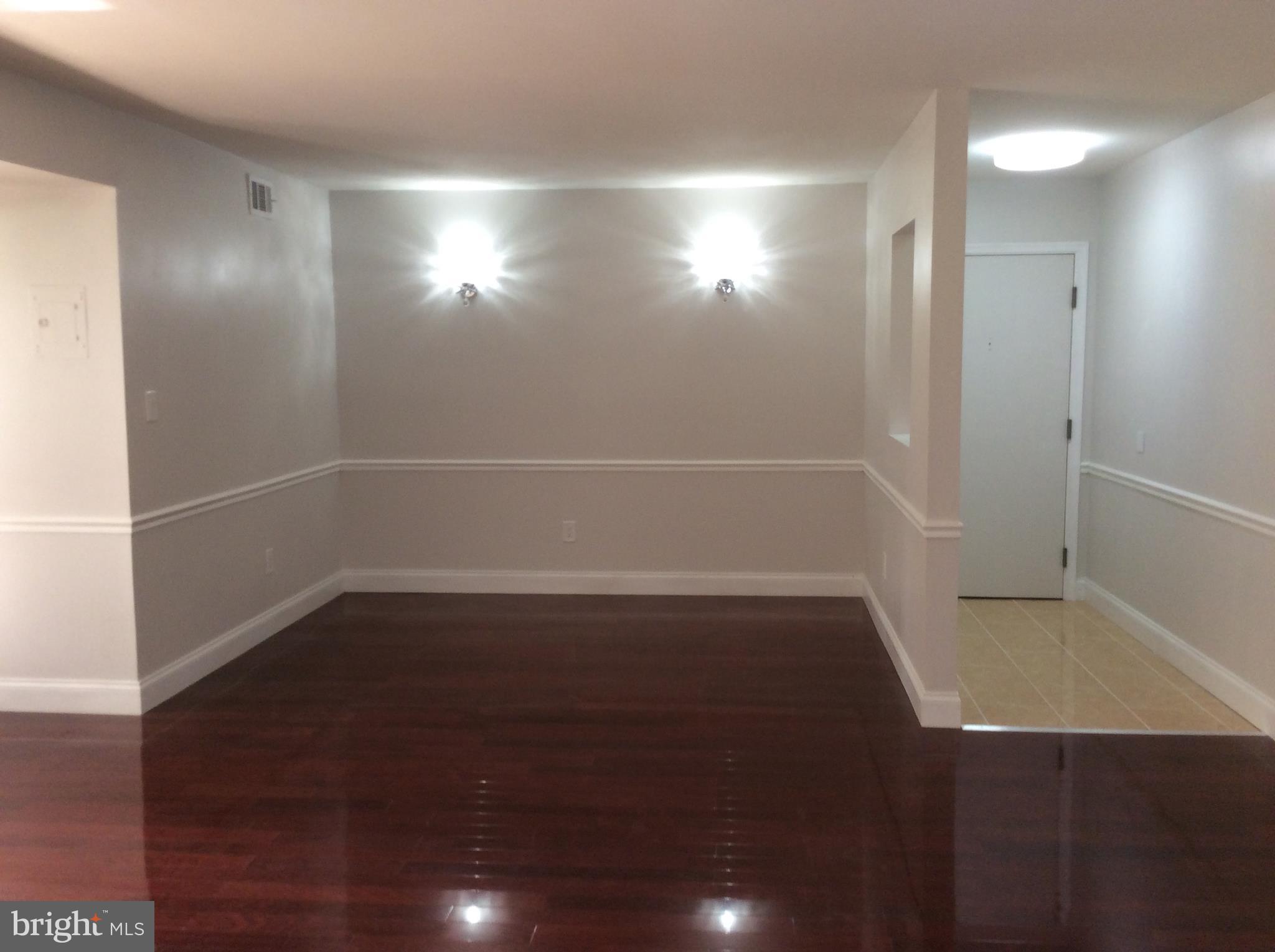 9633 White Acre Road, Unit A2 Columbia, MD 21045 - Photo 8 of 27 a view of empty room with wooden floor