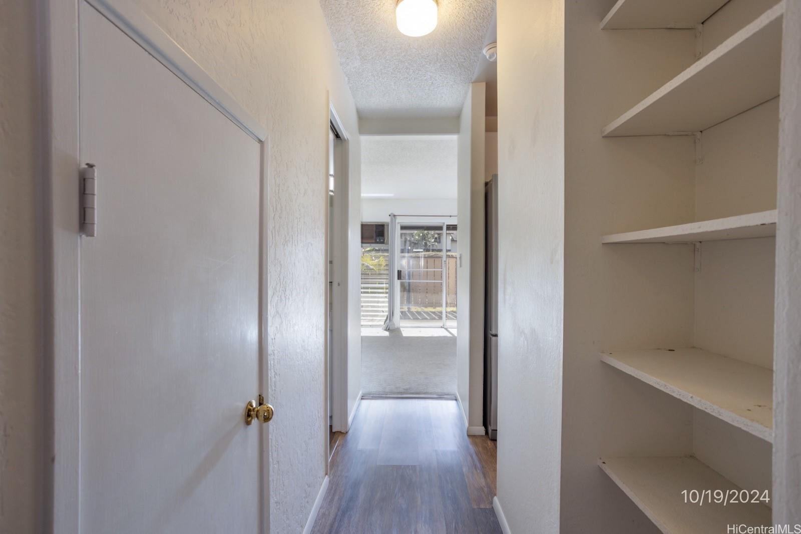 94-112 Anania Drive, Unit 219 Mililani, HI 96789 - Photo 11 of 25 a view of a room with wooden floor