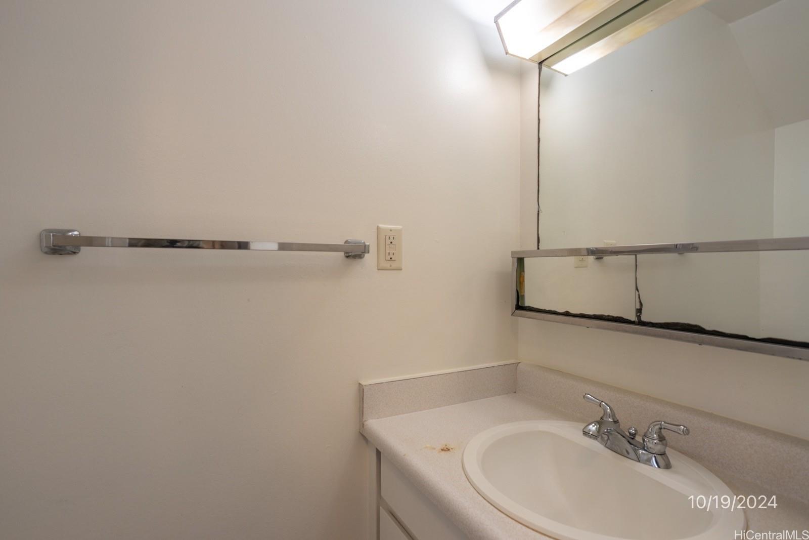 94-112 Anania Drive, Unit 219 Mililani, HI 96789 - Photo 19 of 25 a bathroom with a sink and cabinets