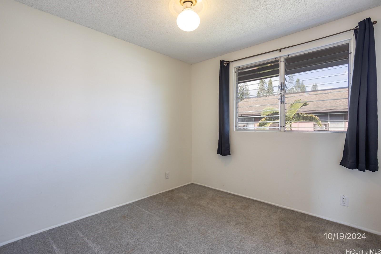 94-112 Anania Drive, Unit 219 Mililani, HI 96789 - Photo 25 of 25 an empty room with a window