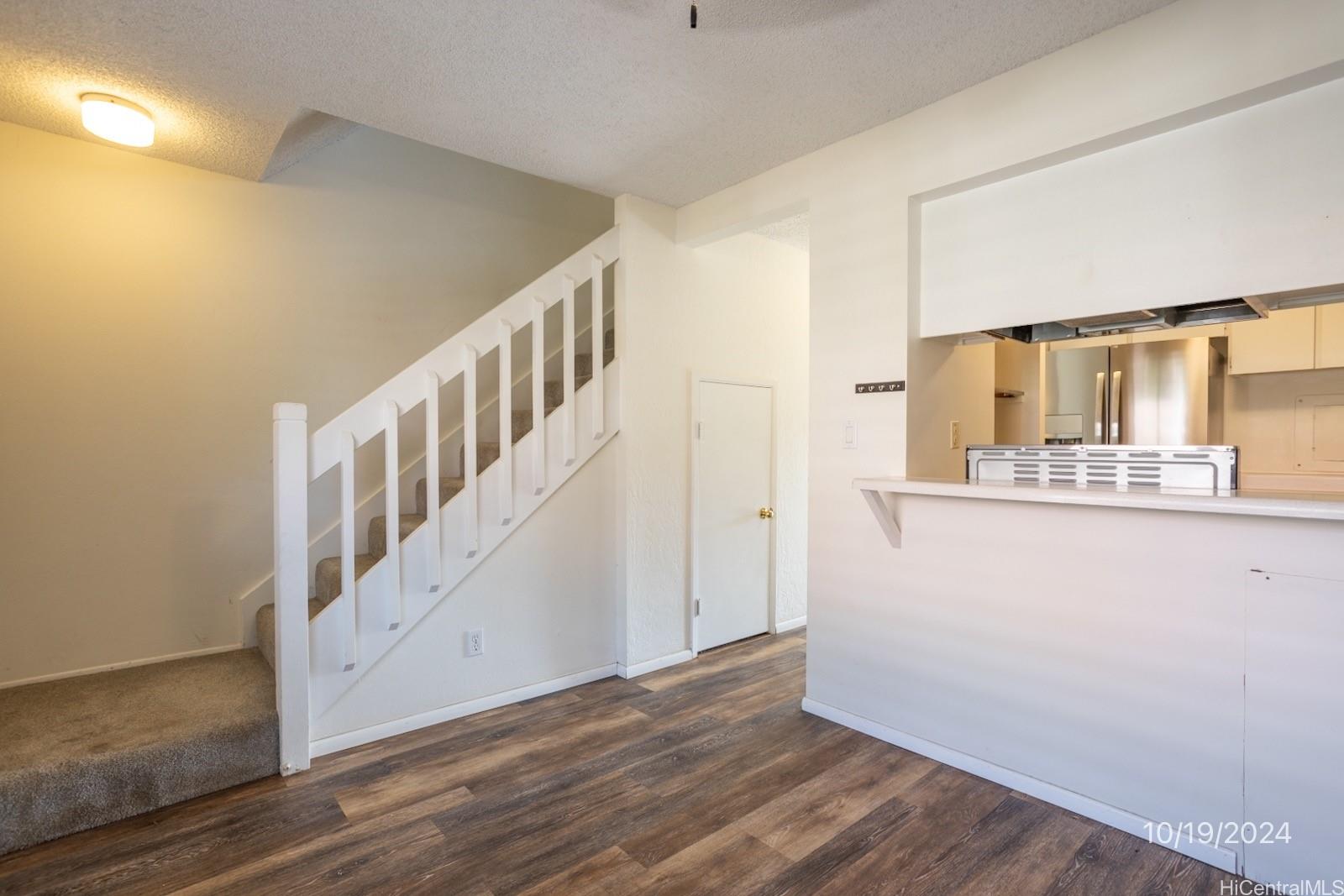94-112 Anania Drive, Unit 219 Mililani, HI 96789 - Photo 8 of 25 a view of a hallway with wooden floor and entryway