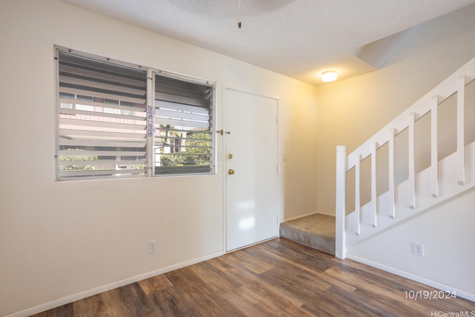 94-112 Anania Drive, Unit 219 Mililani, HI 96789 - Photo 9 of 25 a view of an entryway with wooden floor