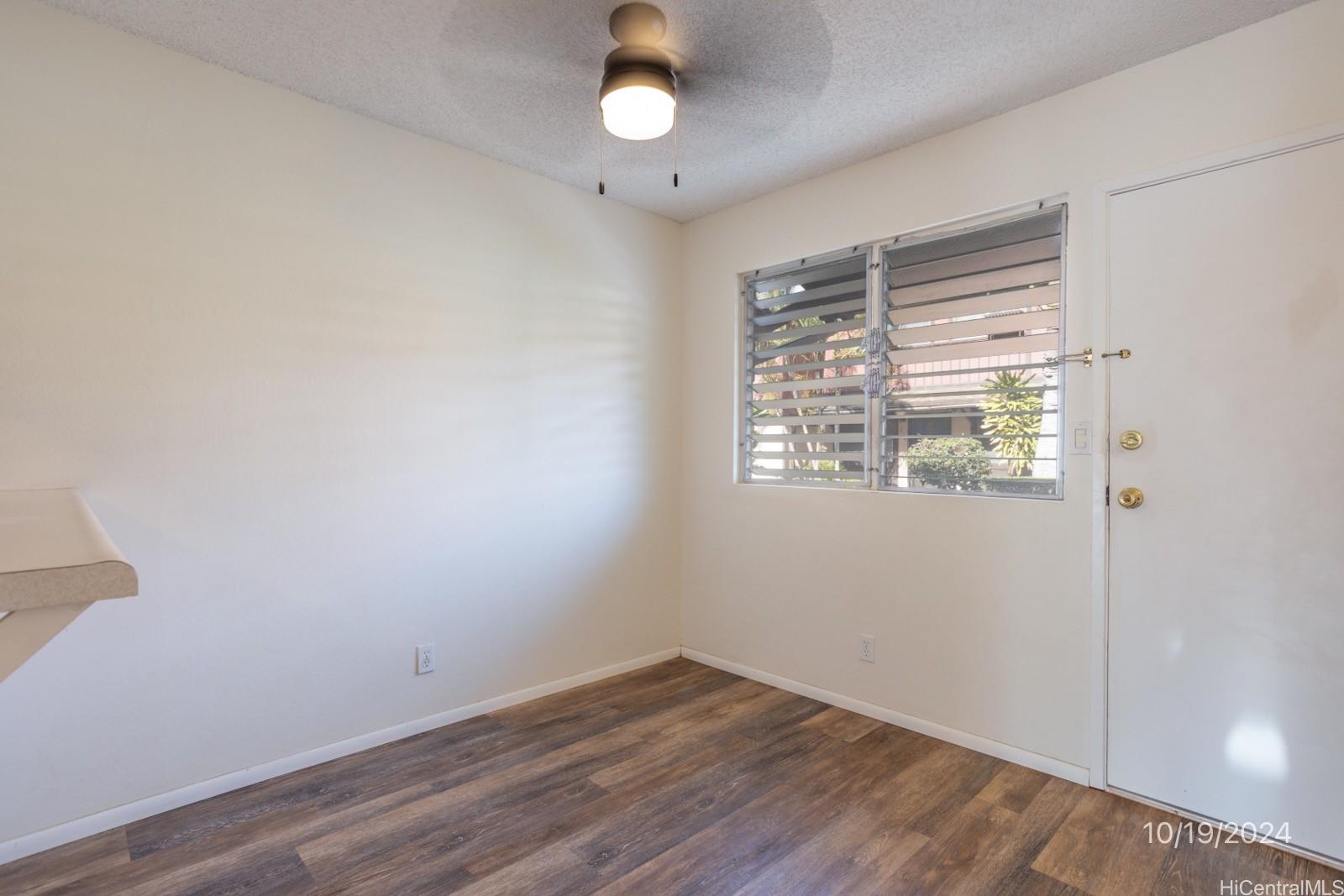 94-112 Anania Drive, Unit 219 Mililani, HI 96789 - Photo 10 of 25 wooden floor in an empty room with a window