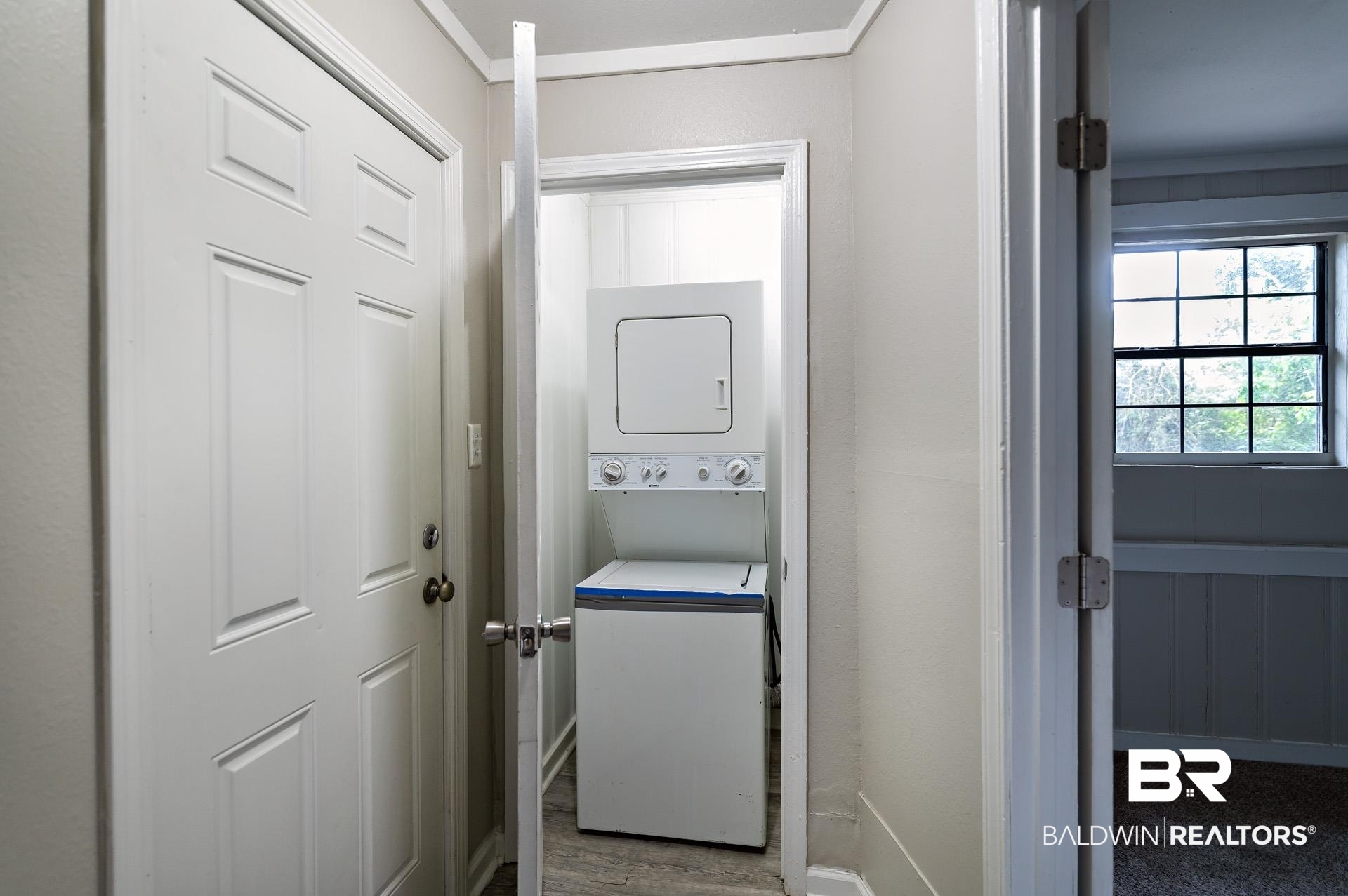 1869 Mott Drive West Mobile, AL 36617 - Photo 27 of 34 Laundry area with baseboards, stacked washing maching and dryer, laundry area, and wood finished floors