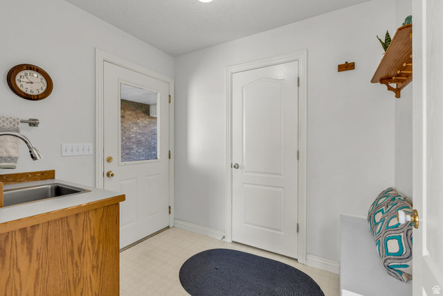 1060 West 2620th Street South Mapleton, UT 84664 - Photo 24 of 87 Doorway to outside featuring tile patterned floors and a sink