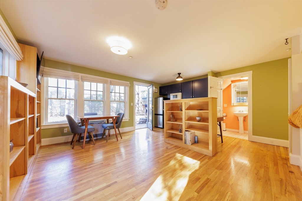 a view of a living room filled with furniture and wooden floor