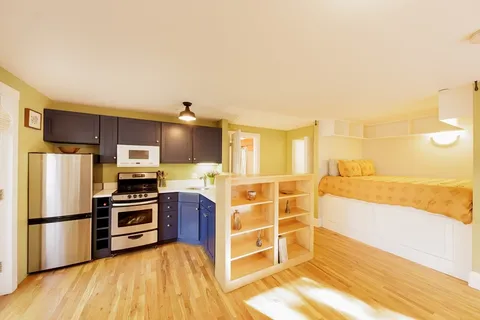 a kitchen with stainless steel appliances a stove a sink and a refrigerator