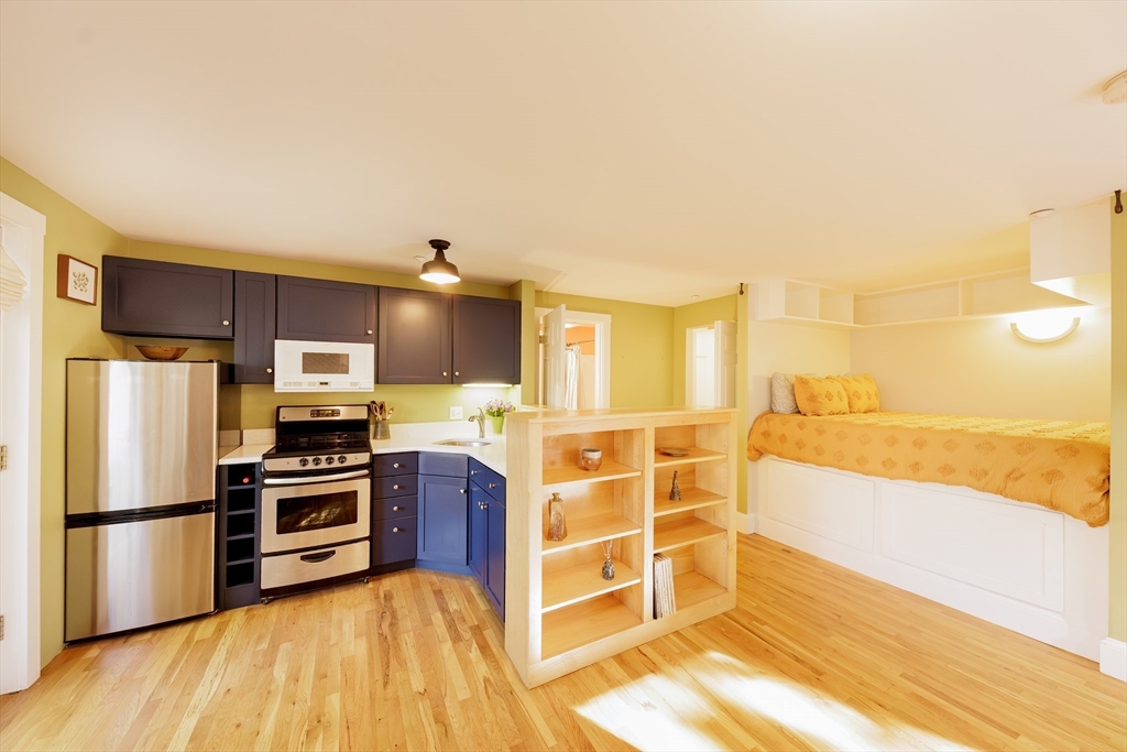 411 Norfolk Street, Unit 1F Somerville, MA 02143 - Photo 4 of 16 a kitchen with stainless steel appliances a stove a sink and a refrigerator