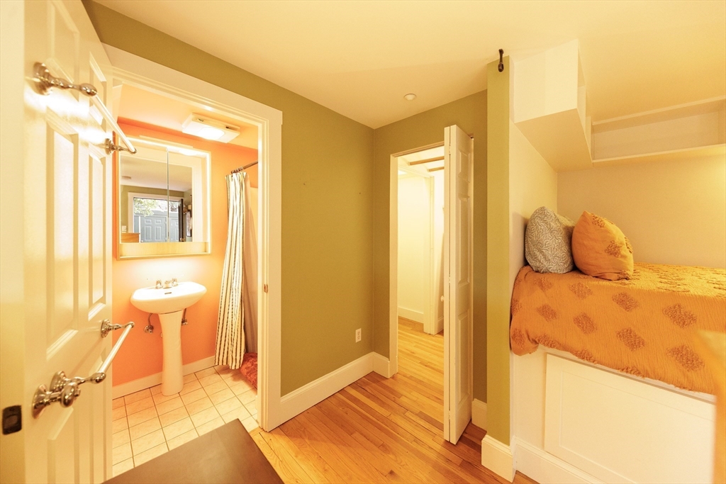 411 Norfolk Street, Unit 1F Somerville, MA 02143 - Photo 6 of 16 a view of a bathroom with a tub and shower