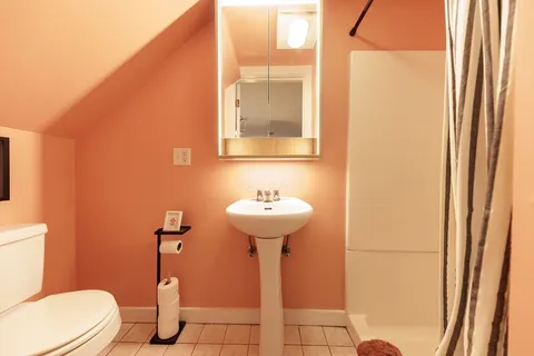 a bathroom with a sink a toilet and mirror
