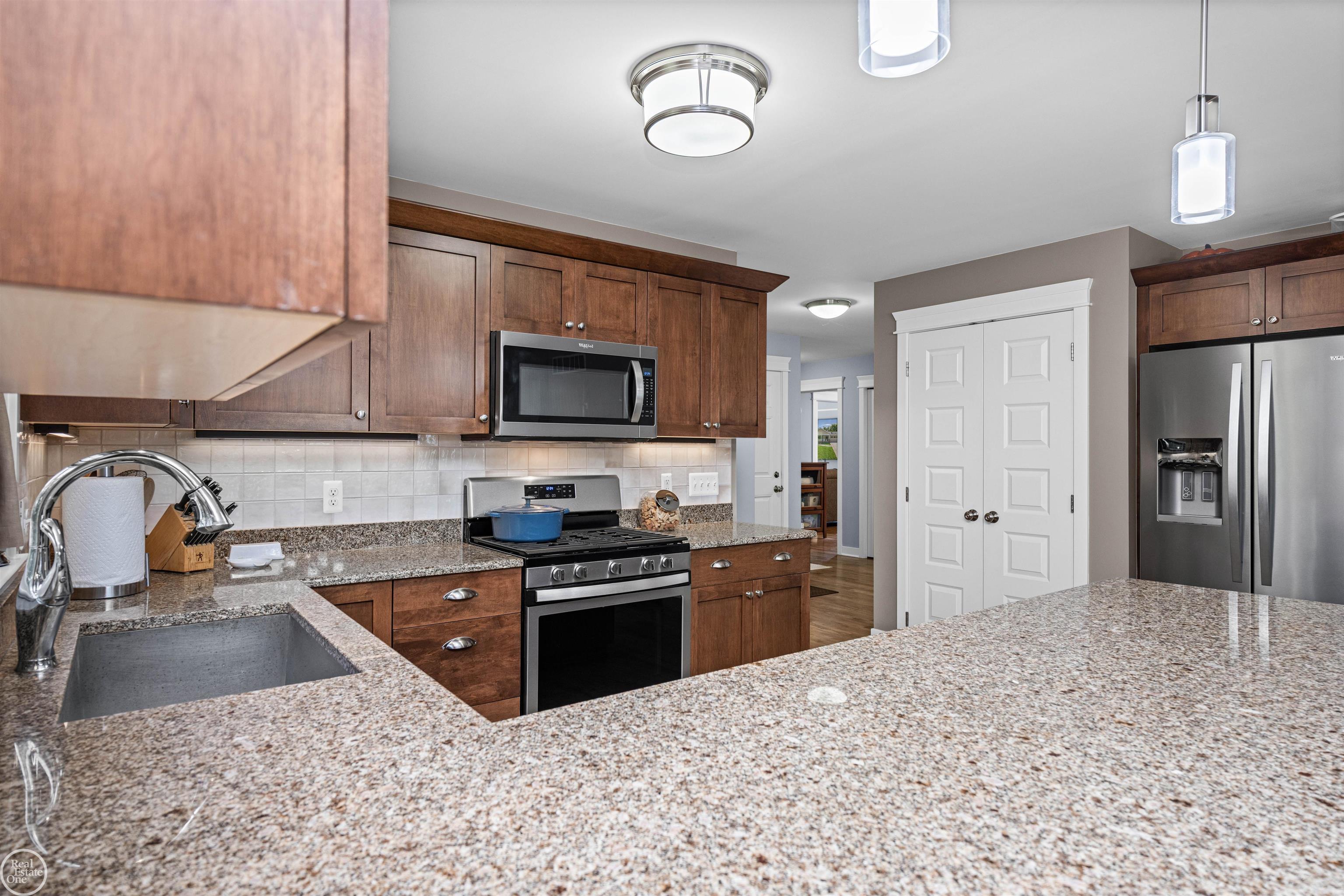 64110 Campground Road Washington, MI 48095 - Photo 42 of 74 Stainless steel Whirlpool appliances and large pantry with interior lighting