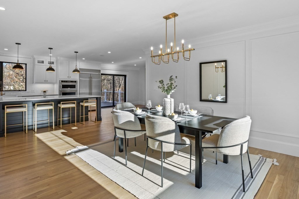 81 Sagamore Street Hamilton, MA 01982 - Photo 20 of 37 a view of a dining room with furniture wooden floor and chandelier