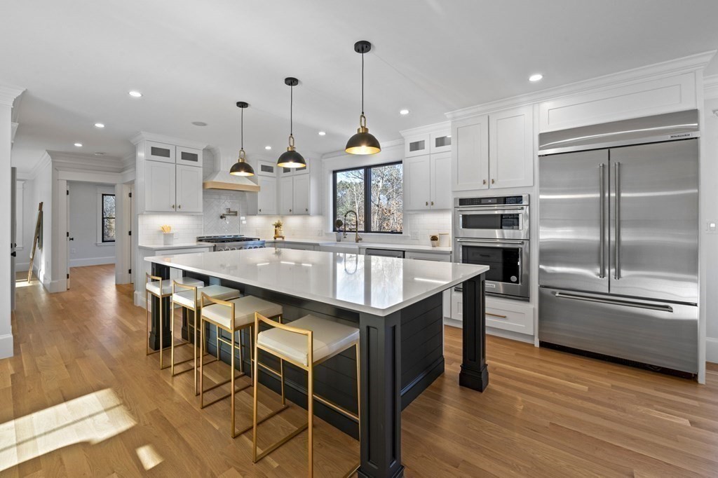 81 Sagamore Street Hamilton, MA 01982 - Photo 8 of 37 a kitchen with stainless steel appliances granite countertop a sink a stove and a refrigerator