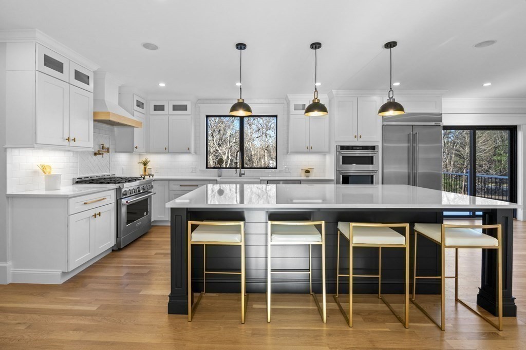 81 Sagamore Street Hamilton, MA 01982 - Photo 9 of 37 a kitchen with granite countertop a stove a sink and chairs