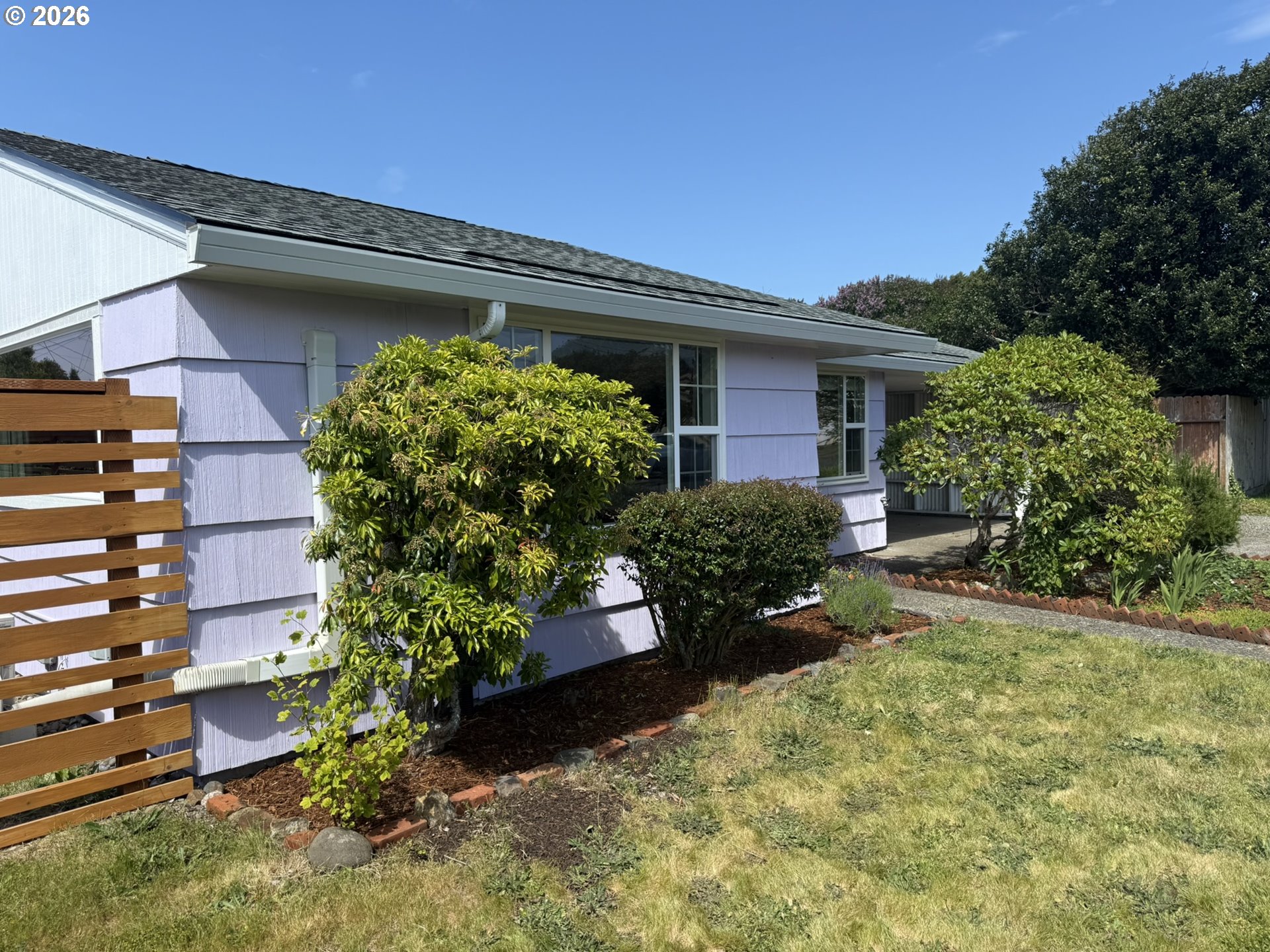 1179 6th Street Florence, OR 97439 - Photo 8 of 26 a front view of a house with a yard