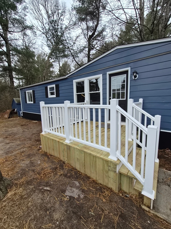 a view of a house with a yard and sitting area