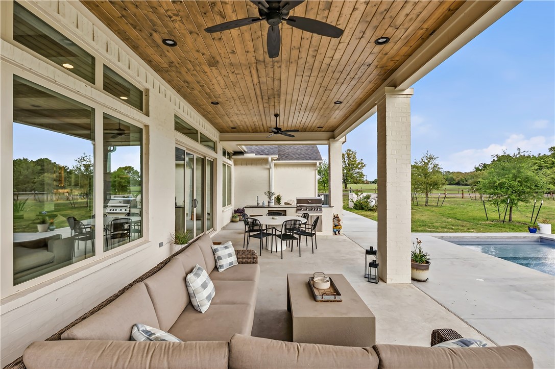 10701 Harvey Ranch Road College Station, TX 77845 - Photo 41 of 48 a living room with patio furniture and a floor to ceiling window