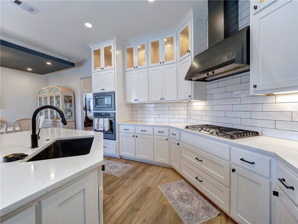 16101 Jessamine Street Corpus Christi, TX 78418 - Photo 14 of 29 a kitchen with granite countertop a sink stainless steel appliances and cabinets
