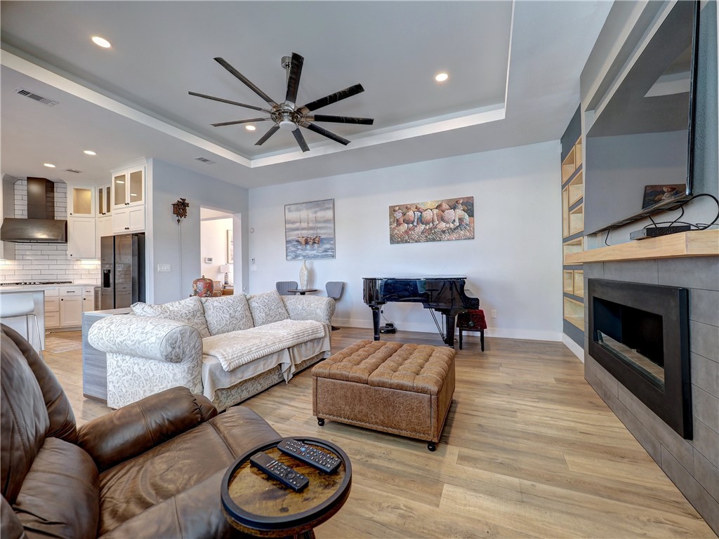 16101 Jessamine Street Corpus Christi, TX 78418 - Photo 16 of 29 a living room with furniture a fireplace and a flat screen tv