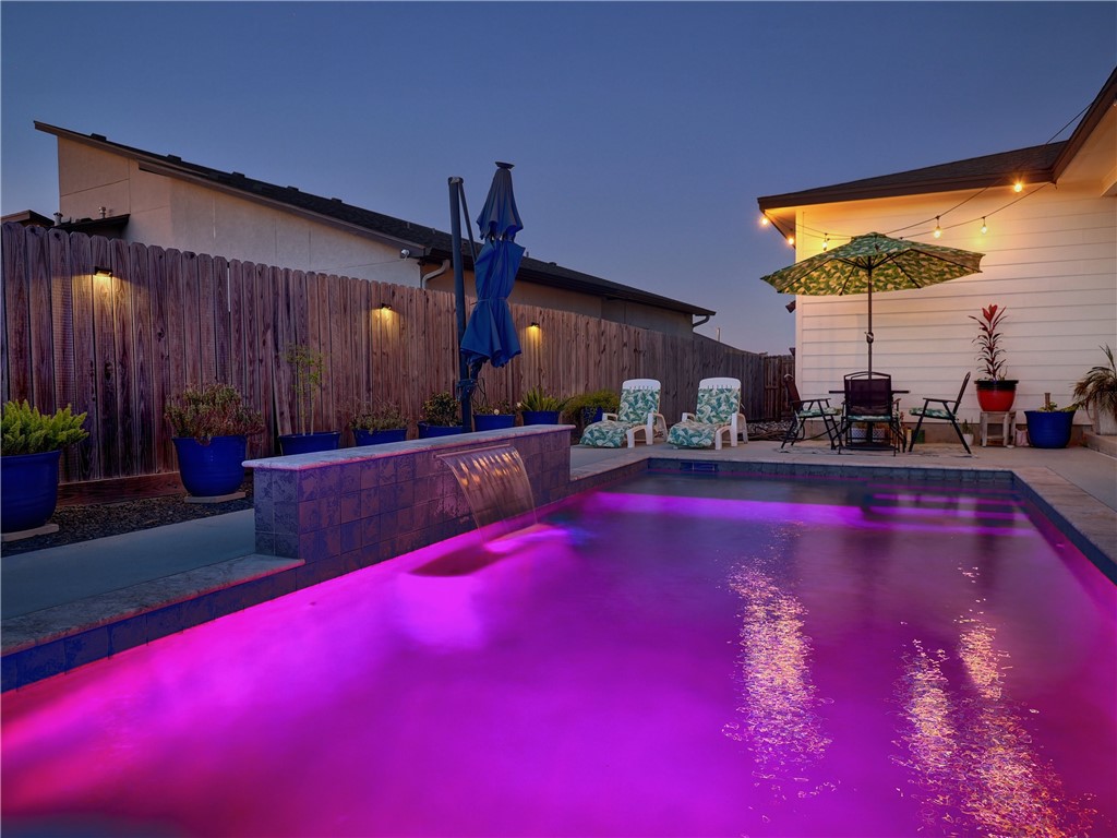 16101 Jessamine Street Corpus Christi, TX 78418 - Photo 25 of 28 a swimming pool with an outdoor seating and a yard
