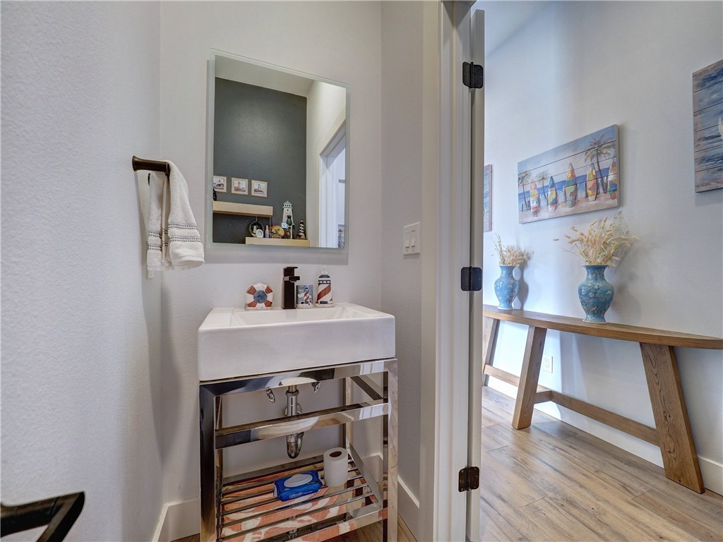 16101 Jessamine Street Corpus Christi, TX 78418 - Photo 9 of 28 a bathroom with a sink a mirror and a toilet