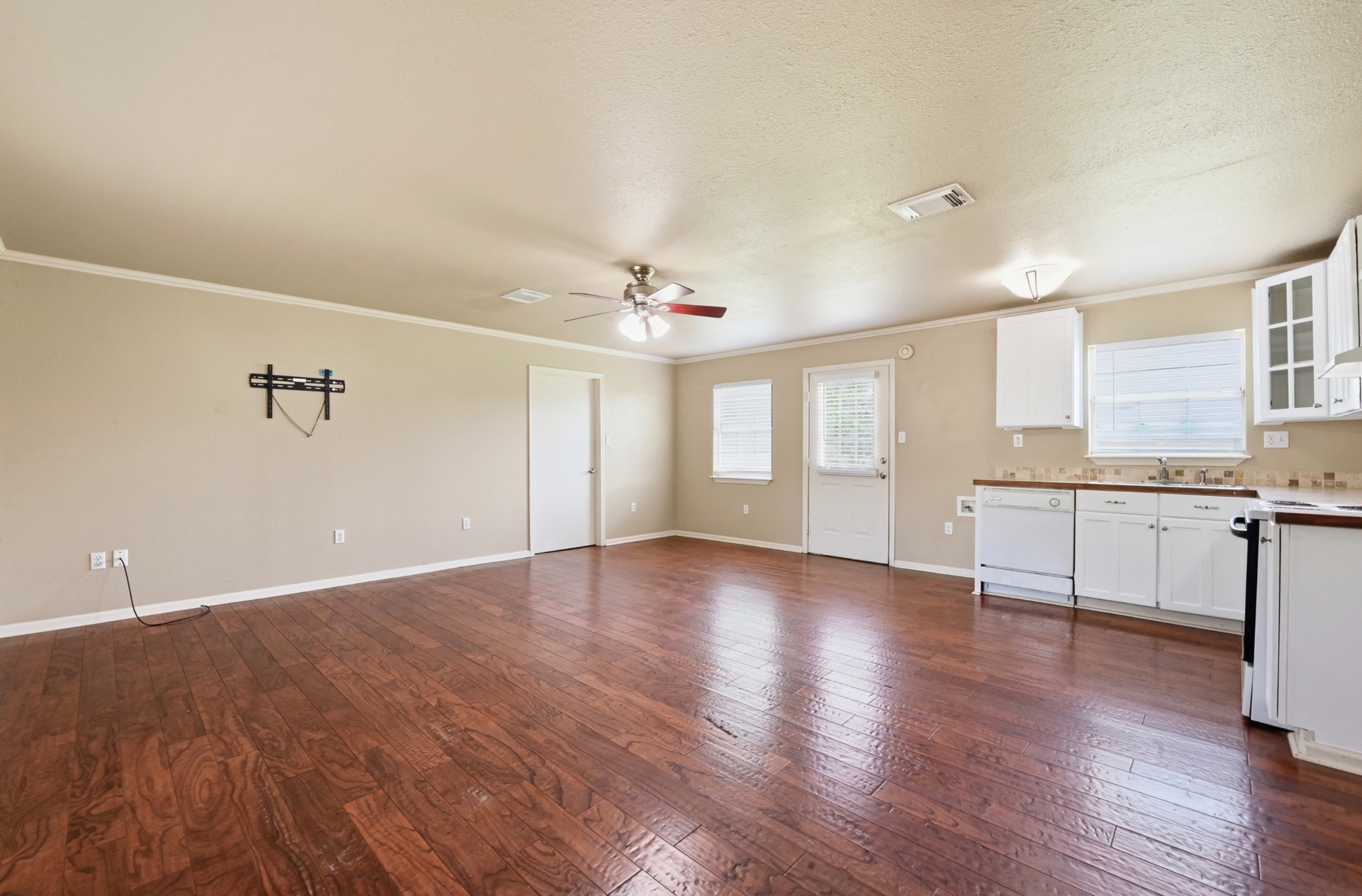 1127 Parr Street Luling, TX 78648 - Photo 5 of 20 Rich hardwood floors unite an open-concept living space with a functional kitchen.