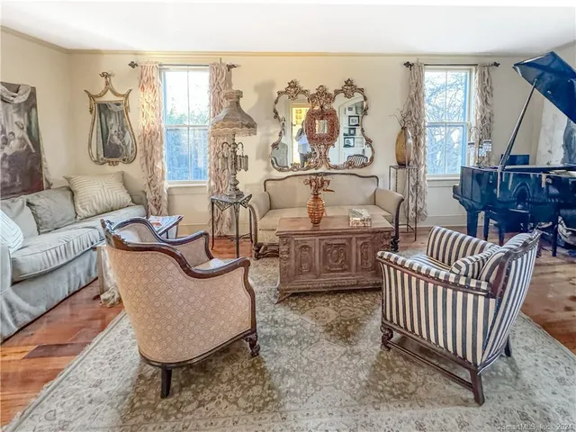 a living room with furniture a couch and a floor to ceiling window