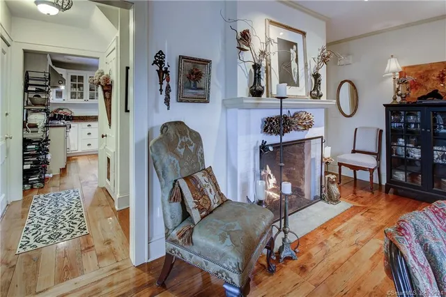 a living room with furniture a rug and wall paintings