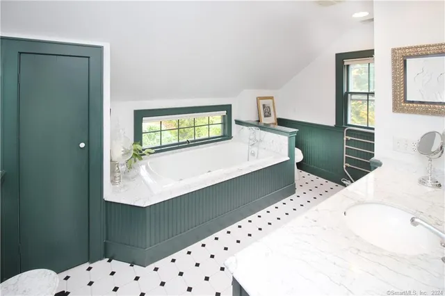 a room with a bed and a dresser