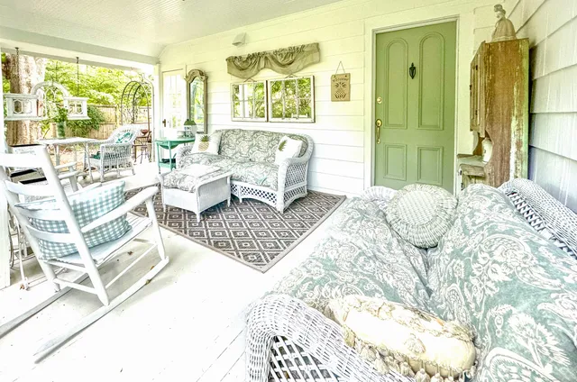 a living room with furniture and a floor to ceiling window