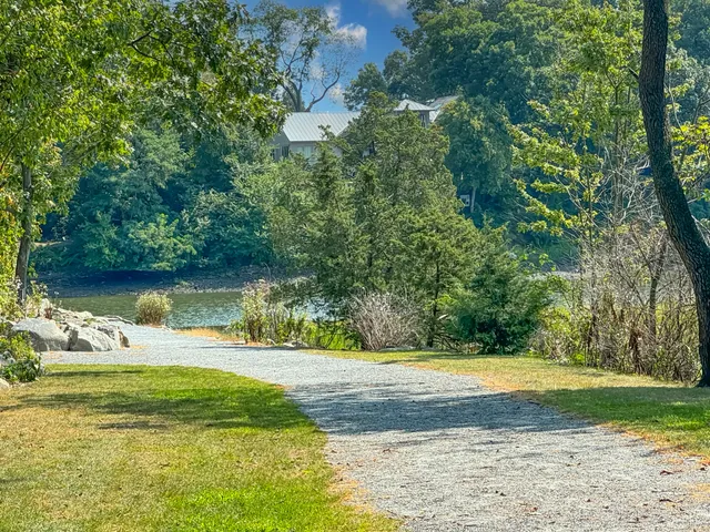 a view of a lake with table and chairs